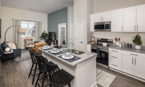 Prose McCullough Station Well lit kitchen with island and bar stools